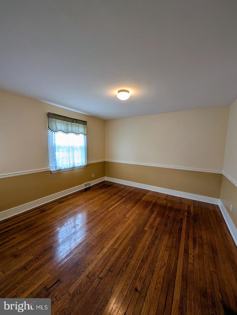 411 Devon Road Camp Hill, PA 17011 - Photo 11 of 33 an empty room with wooden floor and windows