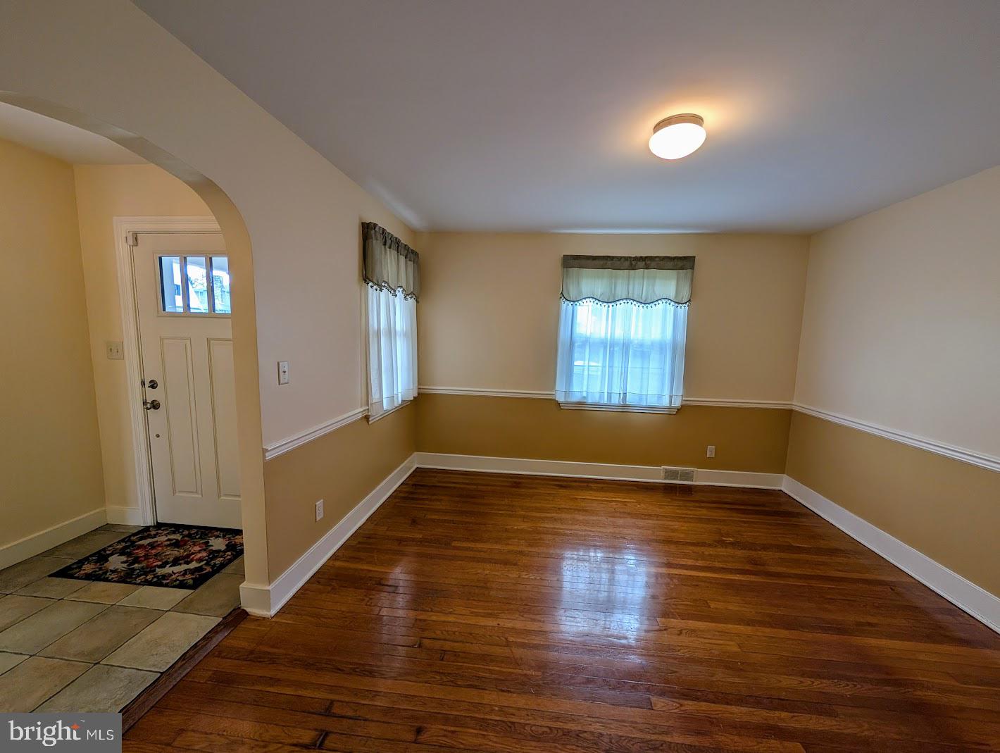 411 Devon Road Camp Hill, PA 17011 - Photo 12 of 33 an empty room with wooden floor and windows