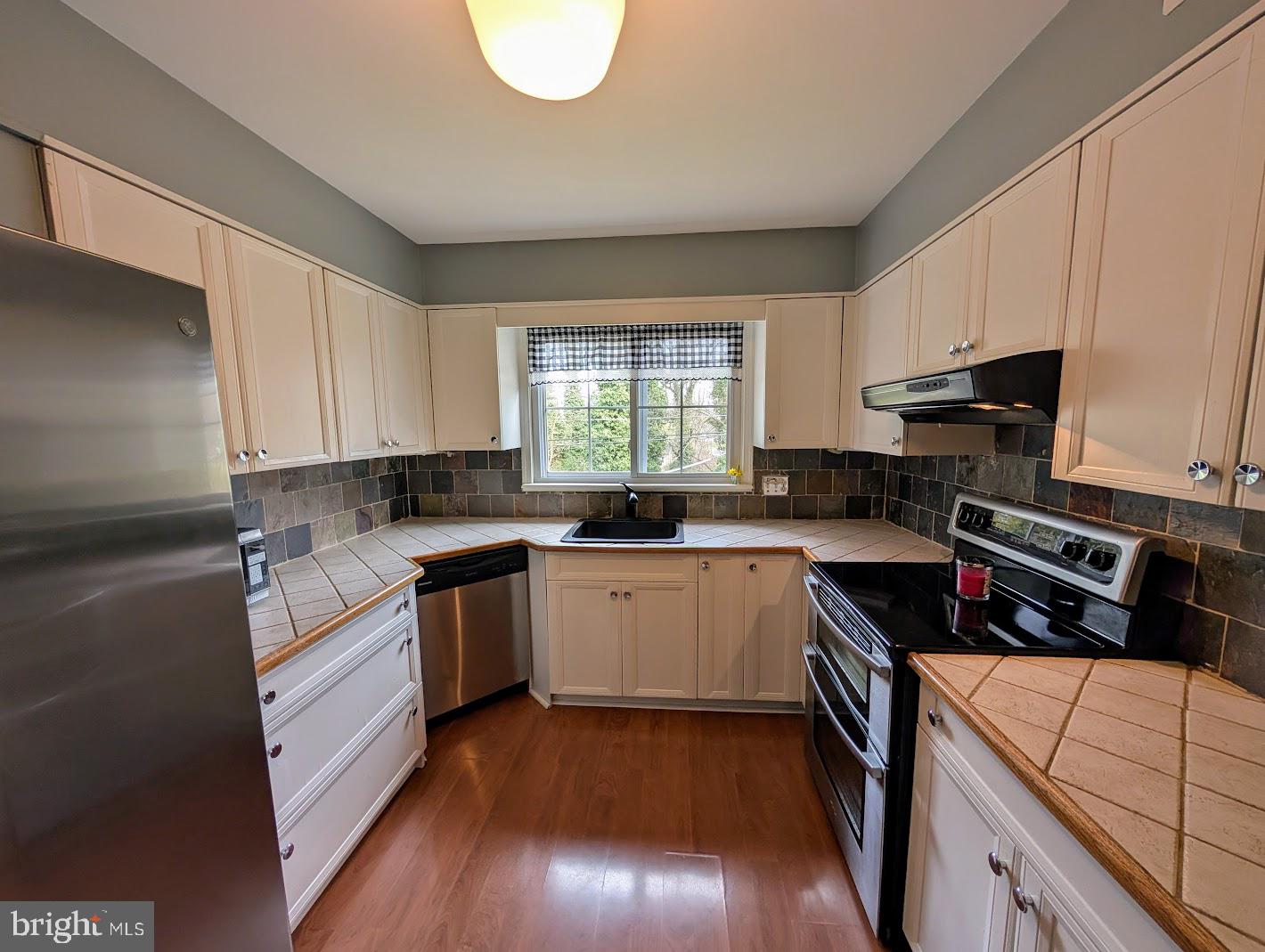 411 Devon Road Camp Hill, PA 17011 - Photo 17 of 33 a kitchen with a sink stove top oven and cabinets