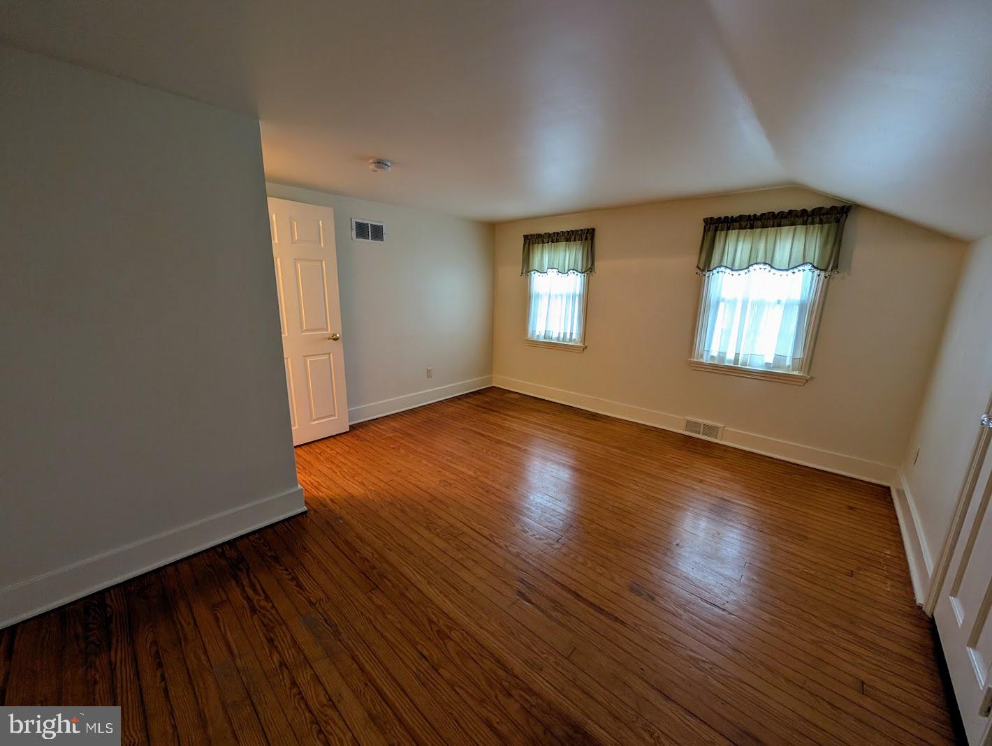 411 Devon Road Camp Hill, PA 17011 - Photo 20 of 33 an empty room with wooden floor and windows