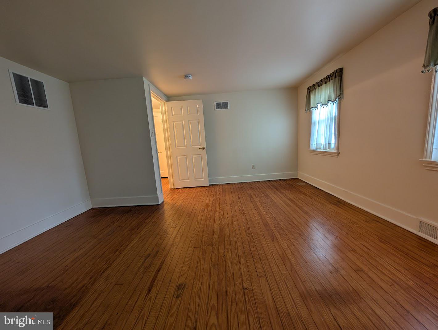411 Devon Road Camp Hill, PA 17011 - Photo 21 of 33 a view of an empty room with wooden floor and a window