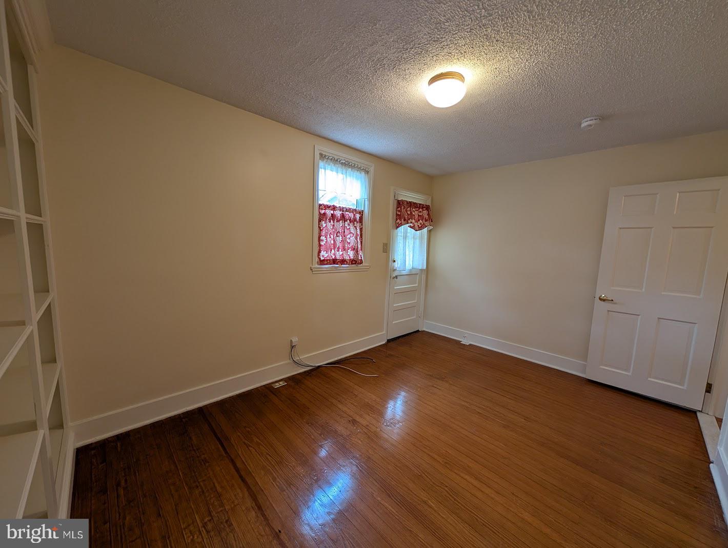 411 Devon Road Camp Hill, PA 17011 - Photo 24 of 33 an empty room with wooden floor and windows