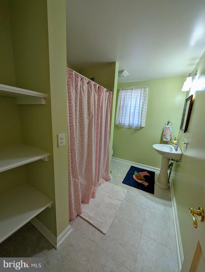 411 Devon Road Camp Hill, PA 17011 - Photo 28 of 33 a bedroom with a bed and a chandelier