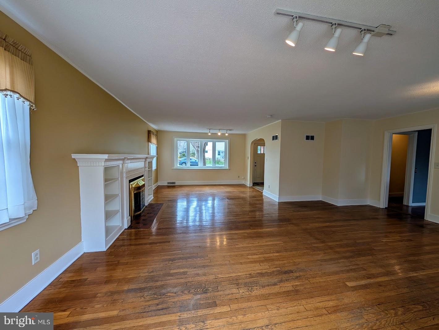 411 Devon Road Camp Hill, PA 17011 - Photo 7 of 33 a view of empty room with wooden floor and fireplace