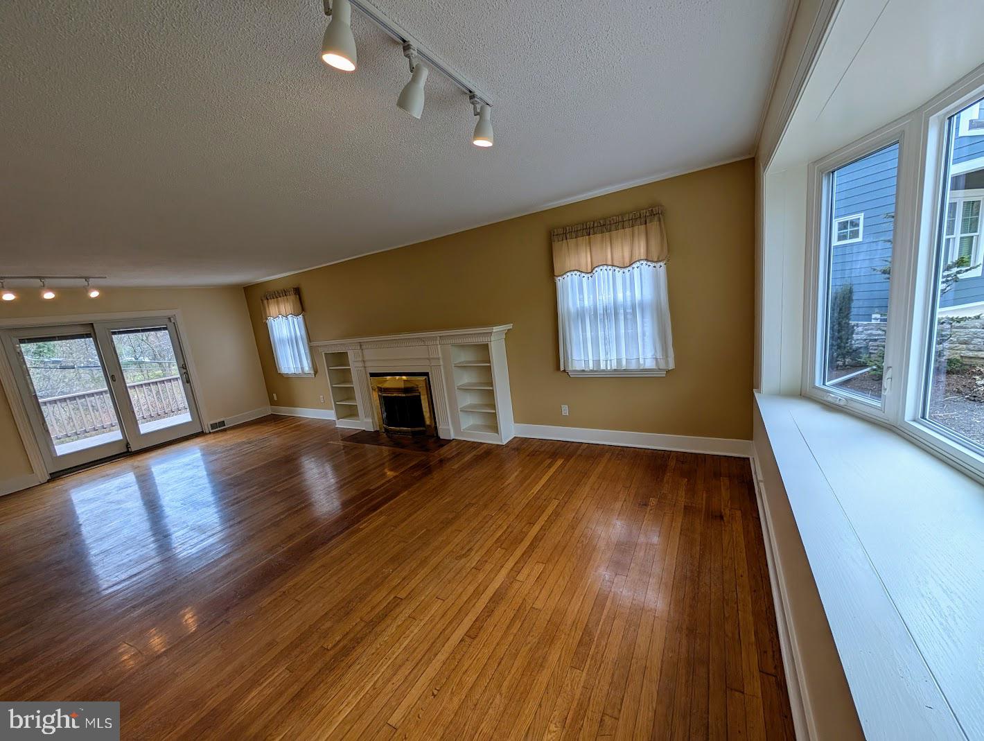 411 Devon Road Camp Hill, PA 17011 - Photo 10 of 33 a view of empty room with fireplace and wooden floor