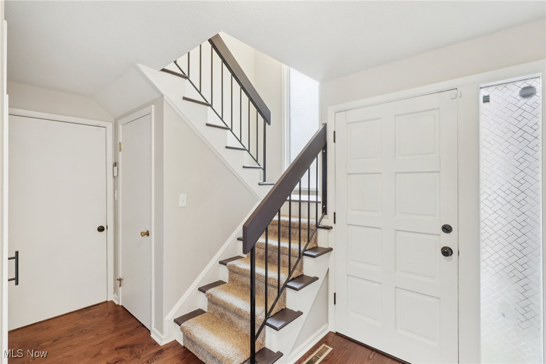 934 Canyon View Road Northfield, OH 44067 - Photo 11 of 24 Foyer entrance featuring dark wood-type flooring, stairway, and lofted ceiling