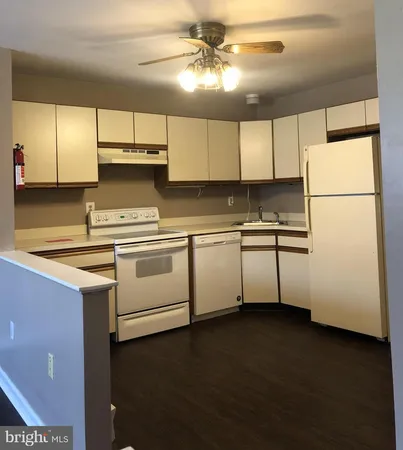 a kitchen with a refrigerator a stove a sink and a microwave