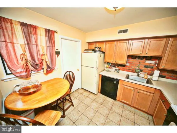 a kitchen with a sink cabinets and appliances