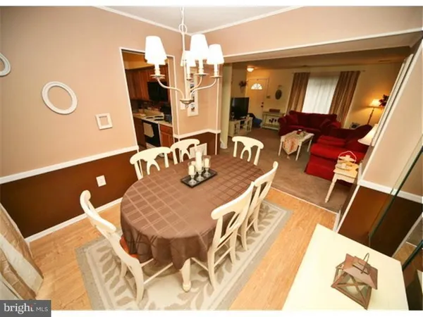 a dining room with furniture and a chandelier