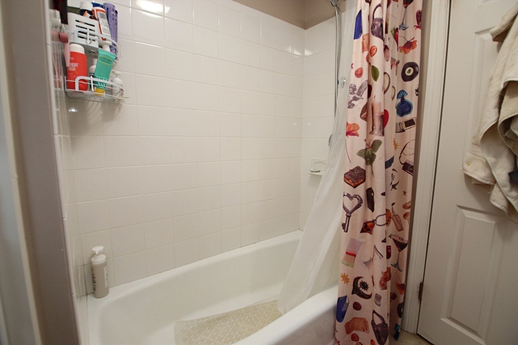 18 Nason Road Saugus, MA 01906 - Photo 20 of 31 a bathroom with a bathtub and shower curtain