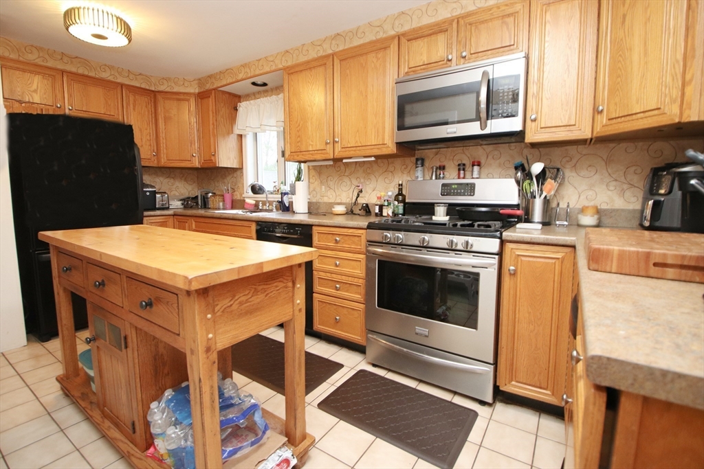 18 Nason Road Saugus, MA 01906 - Photo 5 of 31 a kitchen with a stove a sink and a refrigerator