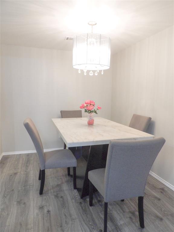 223 Juniper Ridge Court DeSoto, TX 75115 - Photo 12 of 33 Dining space with light wood-style flooring and baseboards