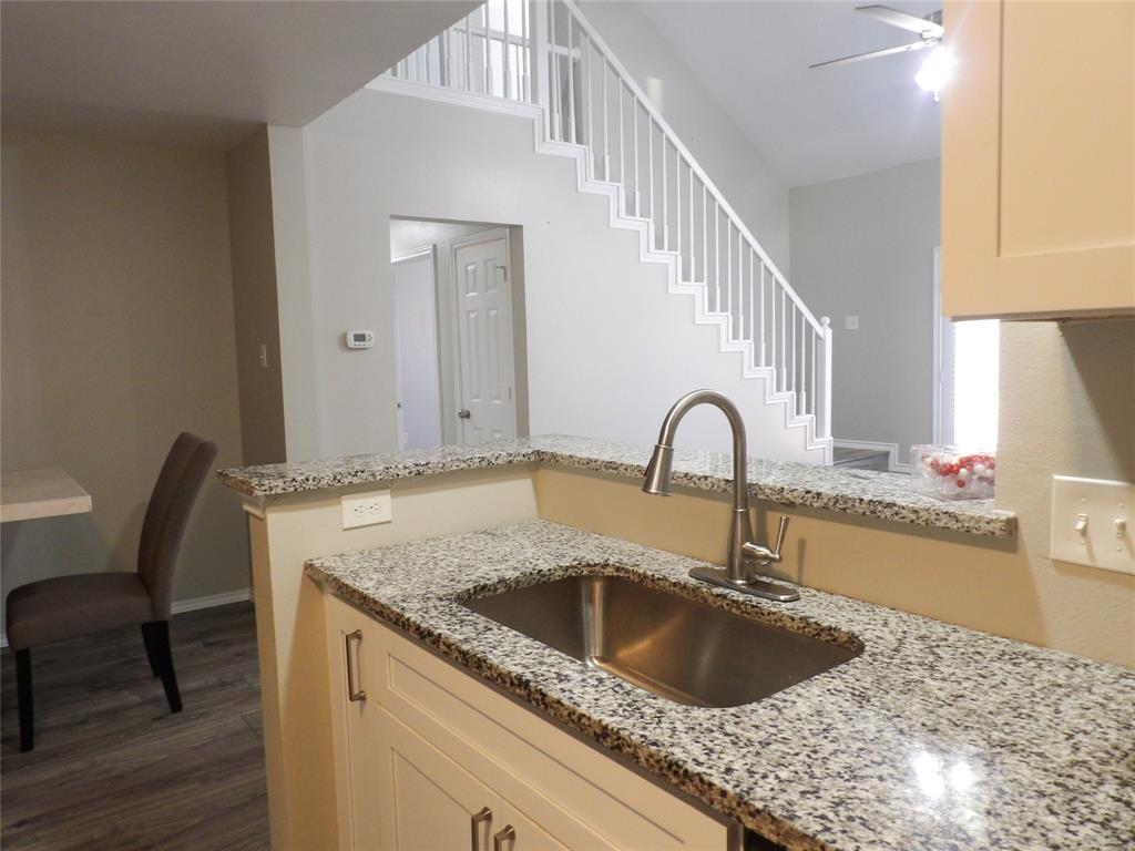 223 Juniper Ridge Court DeSoto, TX 75115 - Photo 29 of 33 Kitchen featuring dark wood-style floors, light stone countertops, ceiling fan, a peninsula, and white cabinets
