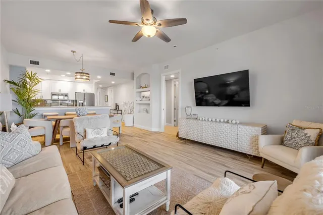 a living room with furniture a flat screen tv and a large window
