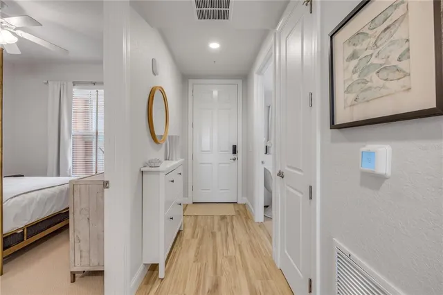 a view of a hallway with wooden floor and furniture
