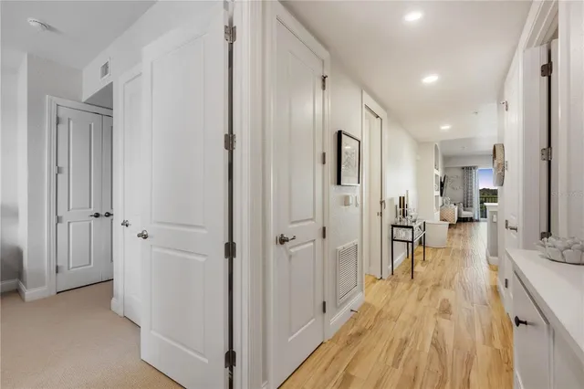 a spacious bedroom with a bed and a chandelier