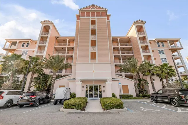 a front view of a residential apartment building with a yard