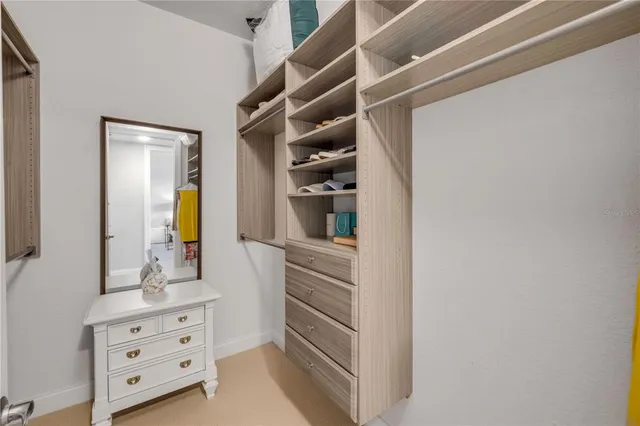 a bathroom with a granite countertop sink mirror bathtub and toilet