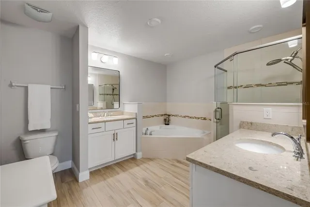 a bathroom with a tub a sink and mirror