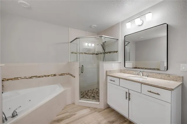a bathroom with a shower and a sink