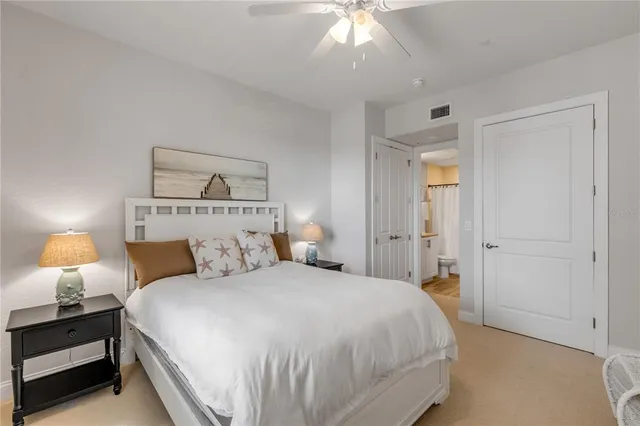 a bedroom with a bed and a mirror