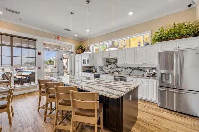 a view of a house with swimming pool and sitting area