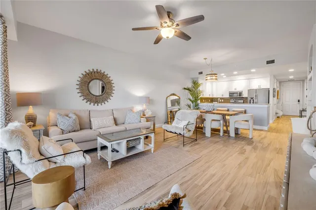 a living room with furniture and kitchen view