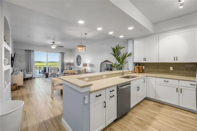 a large kitchen with stainless steel appliances a lot of counter space and a sink