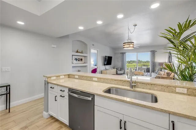 a kitchen with stainless steel appliances a stove sink microwave and cabinets