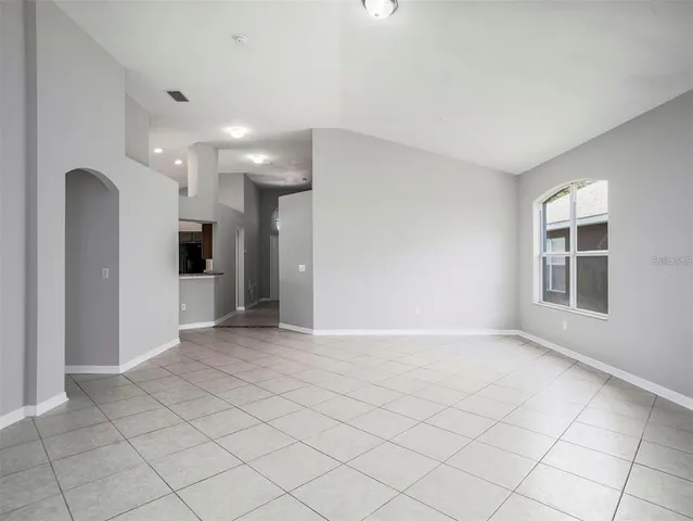 an empty room with windows and entrance