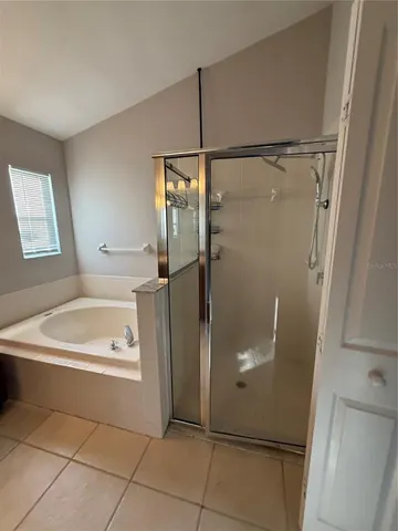 a bathroom with a shower and a sink