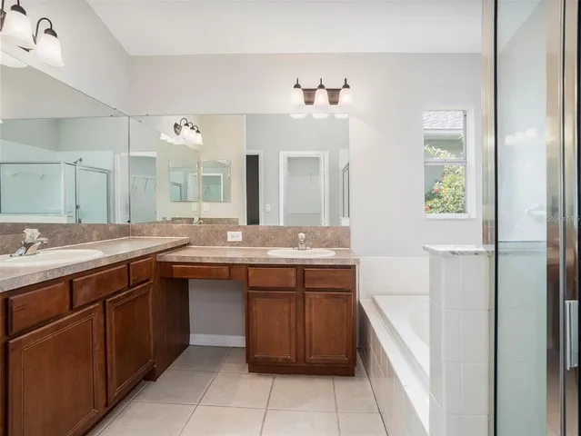 a spacious bathroom with a double vanity sink and a mirror