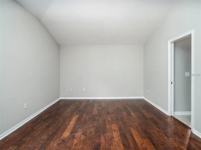 a view of an empty room and wooden floor