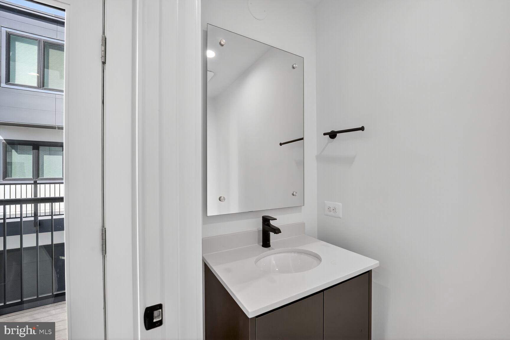 61 Lower Service Road Northwest, Unit HOMESITE 940 Washington, DC 20422 - Photo 12 of 26 a bathroom with a sink and a mirror