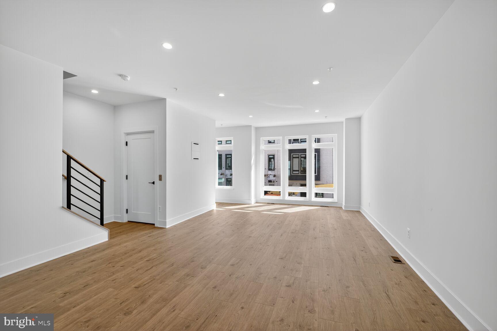 61 Lower Service Road Northwest, Unit HOMESITE 940 Washington, DC 20422 - Photo 13 of 26 a view of an empty room with wooden floor and a window