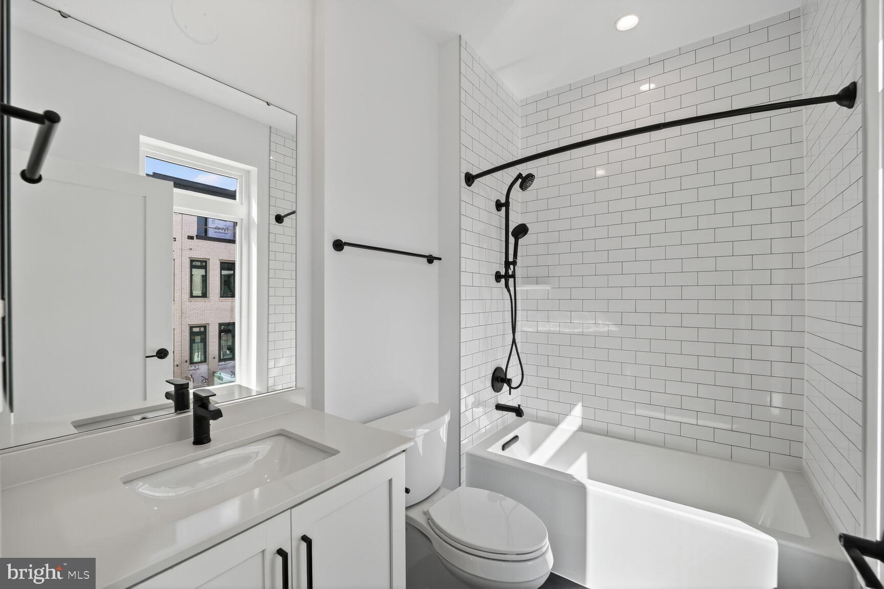 61 Lower Service Road Northwest, Unit HOMESITE 940 Washington, DC 20422 - Photo 19 of 26 a bathroom with a sink a toilet and shower