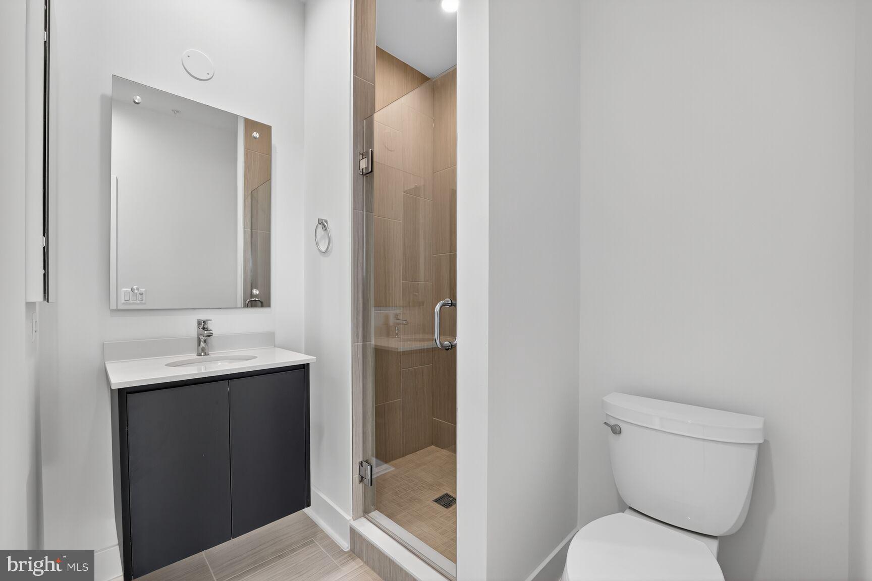 61 Lower Service Road Northwest, Unit HOMESITE 940 Washington, DC 20422 - Photo 22 of 26 a bathroom with a toilet sink and mirror