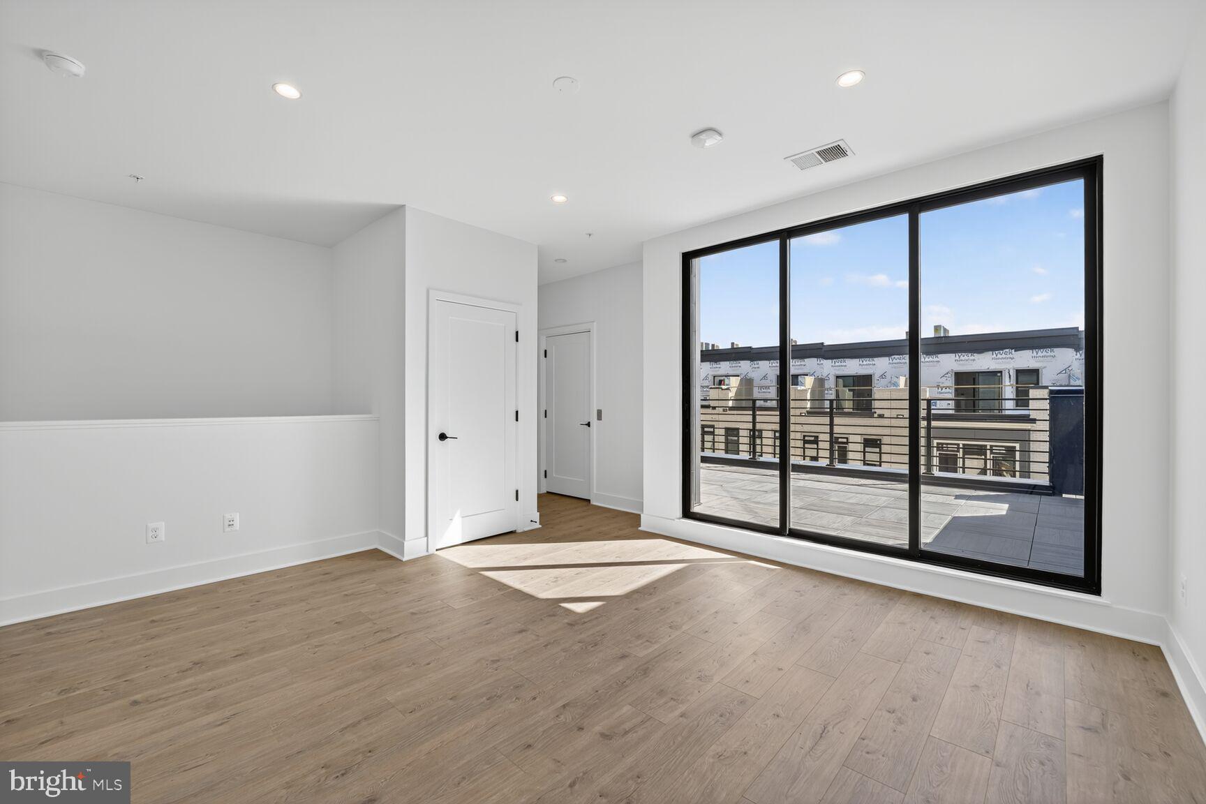 61 Lower Service Road Northwest, Unit HOMESITE 940 Washington, DC 20422 - Photo 24 of 26 a view of an empty room with wooden floor and a window