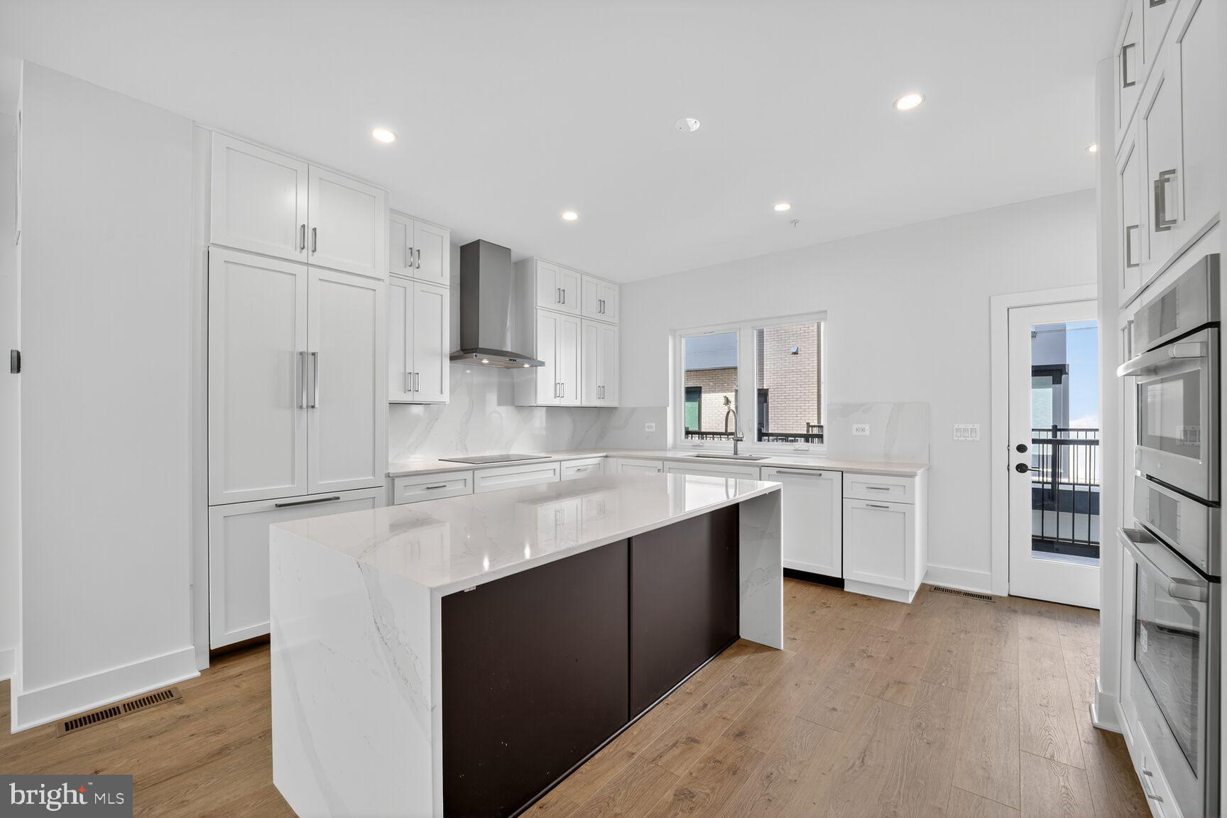 61 Lower Service Road Northwest, Unit HOMESITE 940 Washington, DC 20422 - Photo 6 of 26 a kitchen with stainless steel appliances granite countertop a refrigerator sink and white cabinets