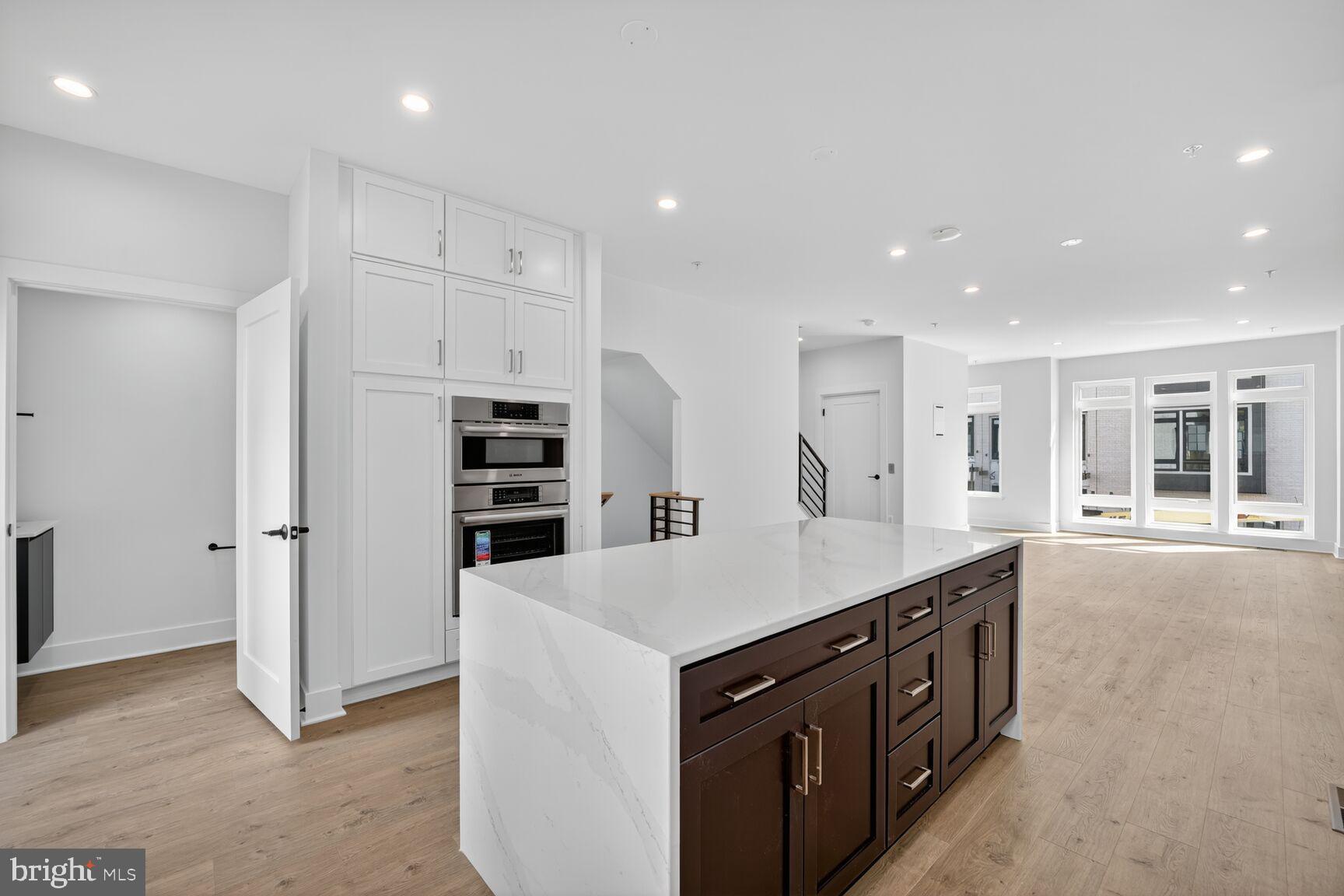 61 Lower Service Road Northwest, Unit HOMESITE 940 Washington, DC 20422 - Photo 7 of 26 a kitchen with kitchen island a counter top space appliances and a center island