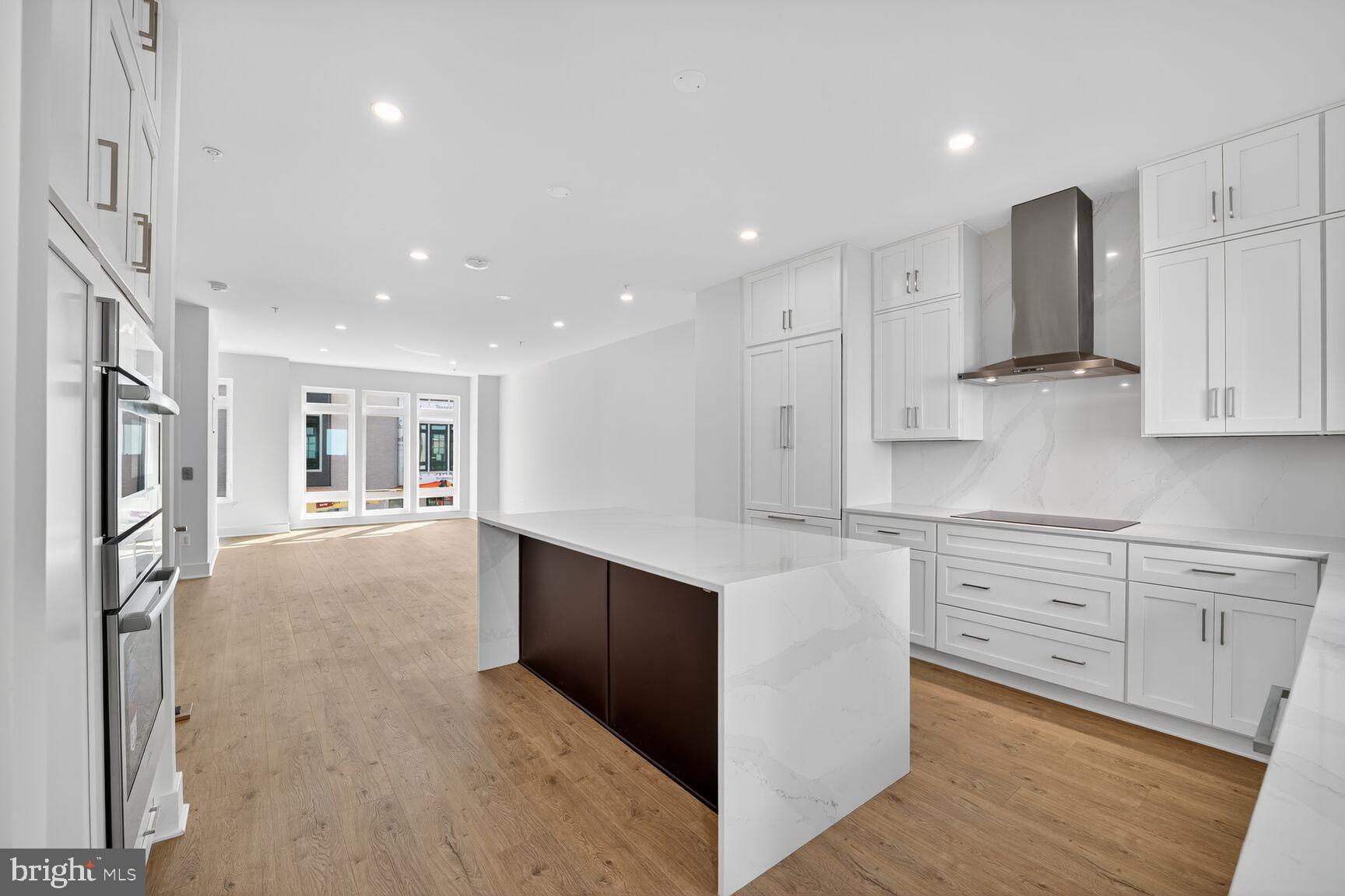 61 Lower Service Road Northwest, Unit HOMESITE 940 Washington, DC 20422 - Photo 8 of 26 a large kitchen with stainless steel appliances cabinets a sink and a stove