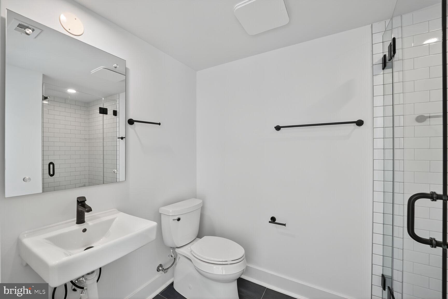 61 Lower Service Road Northwest, Unit HOMESITE 940 Washington, DC 20422 - Photo 9 of 26 a bathroom with a sink a toilet and shower