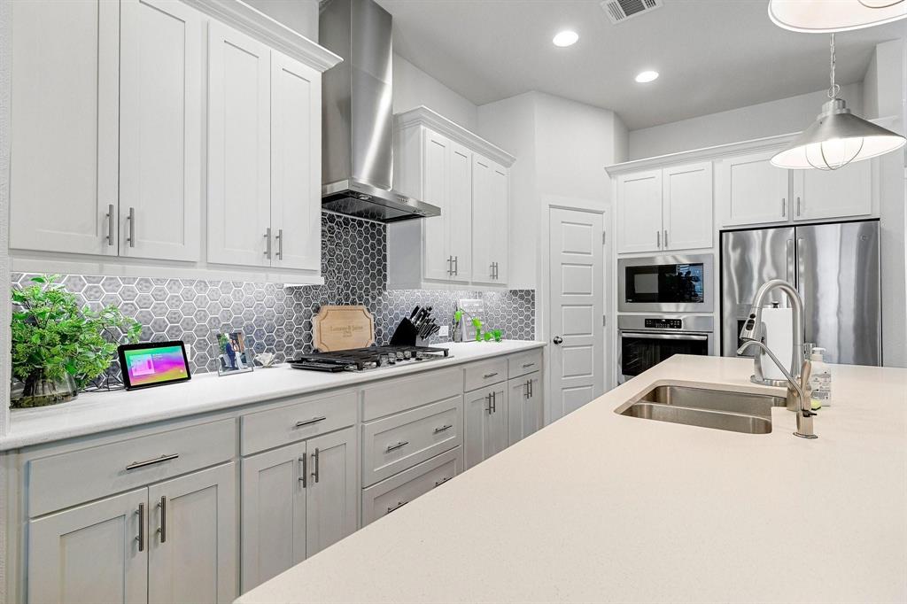 648 Aspen Valley Lane Dallas, TX 75208 - Photo 13 of 38 a kitchen with kitchen island granite countertop a sink stainless steel appliances and cabinets