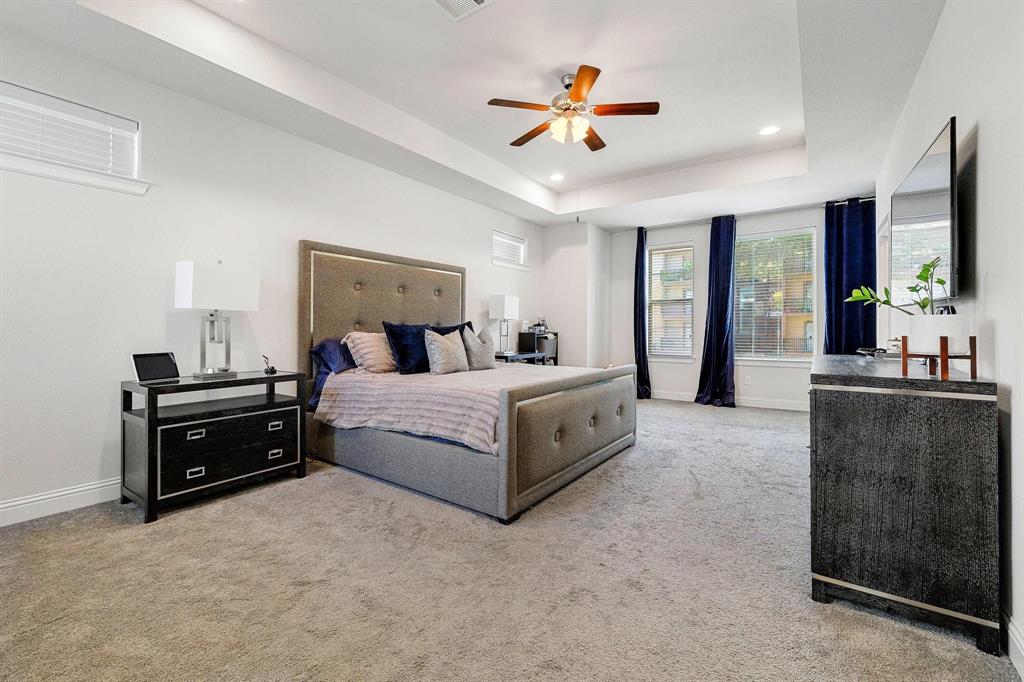 648 Aspen Valley Lane Dallas, TX 75208 - Photo 17 of 38 a bedroom with a large bed and flat screen tv