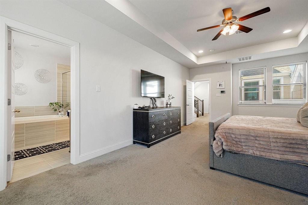 648 Aspen Valley Lane Dallas, TX 75208 - Photo 18 of 38 a spacious bedroom with a bed and a chandelier