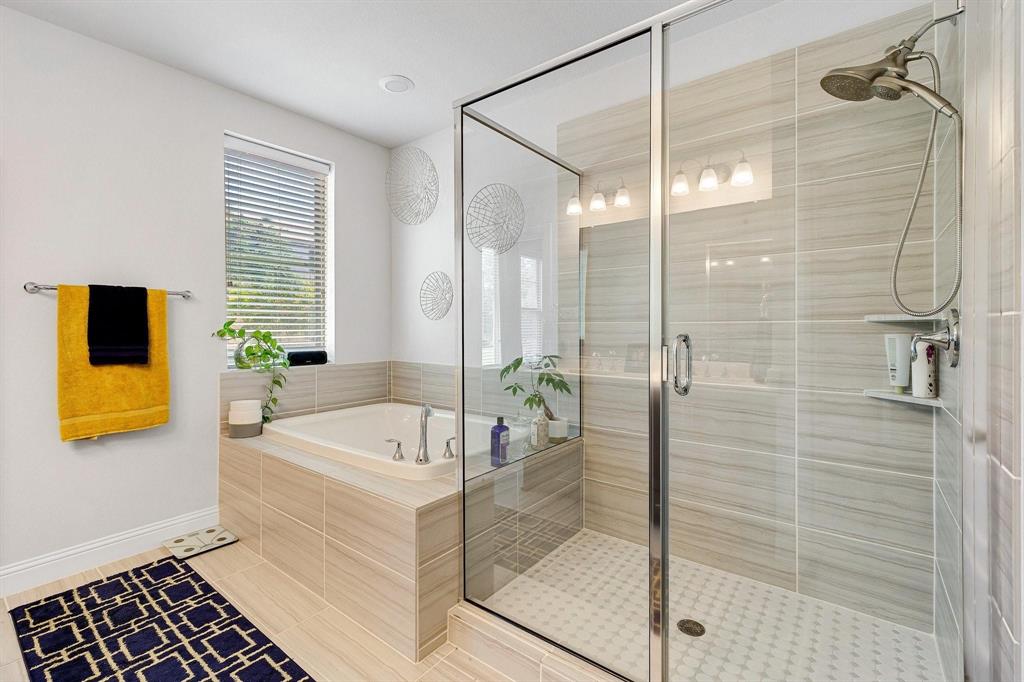648 Aspen Valley Lane Dallas, TX 75208 - Photo 20 of 38 a bathroom with a tub a sink and glass door