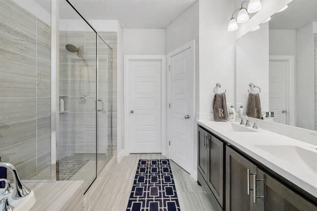 648 Aspen Valley Lane Dallas, TX 75208 - Photo 22 of 38 a bathroom with a sink a mirror and shower