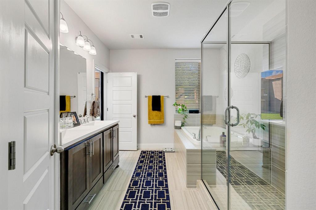 648 Aspen Valley Lane Dallas, TX 75208 - Photo 23 of 38 a bathroom with double vanity and a shower