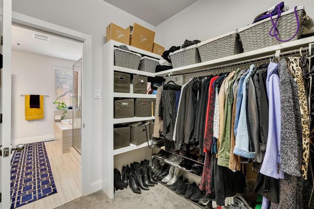 648 Aspen Valley Lane Dallas, TX 75208 - Photo 24 of 38 a view of walk in closet with clothes and shoes