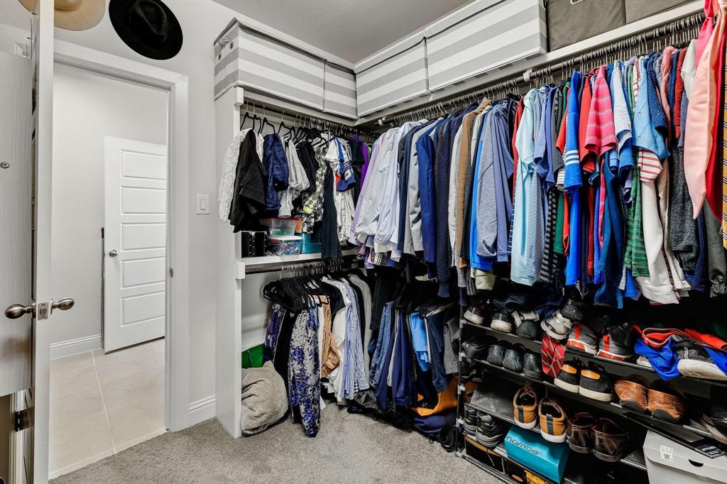 648 Aspen Valley Lane Dallas, TX 75208 - Photo 25 of 38 a view of walk in closet with clothes and shoes
